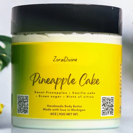 Jar of ZoraiDivine Pineapple Cake body butter with a yellow label and black lid.