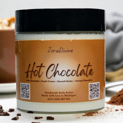 ZoraiDivine Hot Chocolate body butter jar with a blurred background