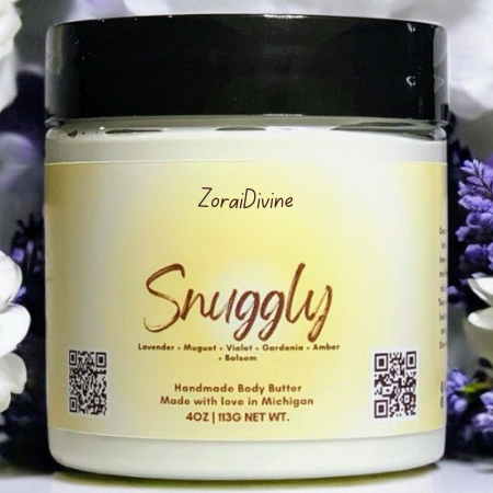 Jar of ZoraiDivine Snuggly body butter with a black lid and floral background