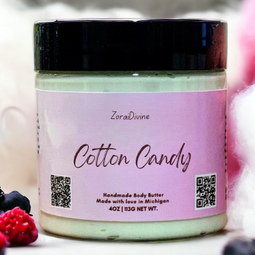 Jar of cotton candy body butter with berries and fluffy cotton candy in the background