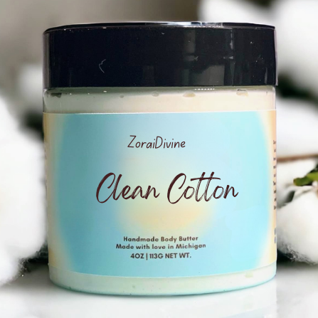 Jar of ZoraiDivine Clean Cotton handmade body butter with a black lid on a white background.