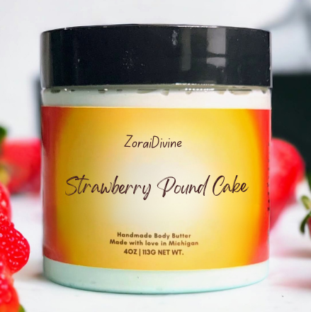 Jar of ZoraiDivine Strawberry Pound Cake body butter with strawberries in the background