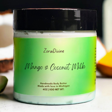 Jar of ZoraiDivine Mango & Coconut Milk body butter on a light surface.