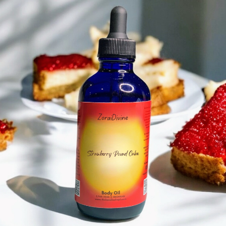 ZoraiDivine Strawberry Pound Cake body oil bottle with desserts in the background