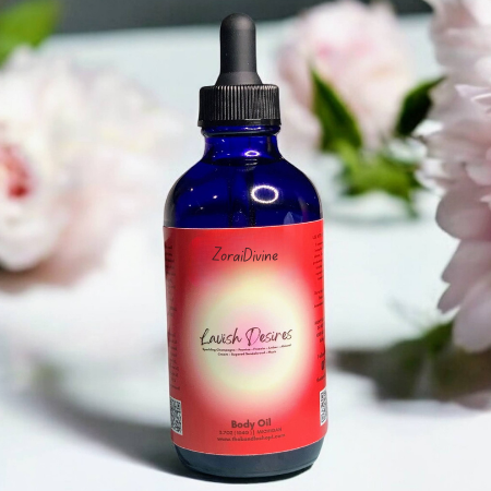 Bottle of ZoraiDivine Lavish Desires body oil with flowers in the background