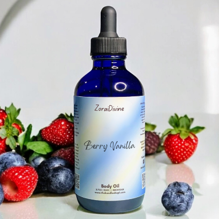 Bottle of ZoraiDivine Berry Vanilla body oil with berries in the background