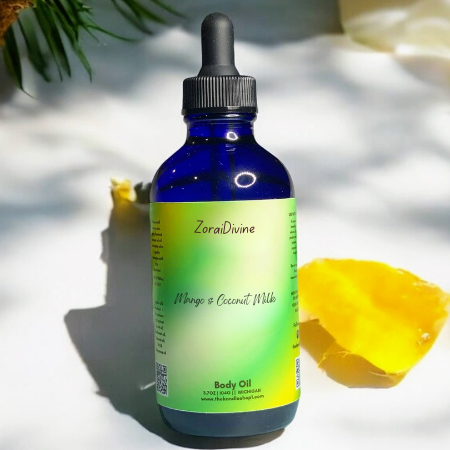 Blue bottle of ZoraiDivine Mango & Coconut Milk Body Oil with a dropper on a light background.