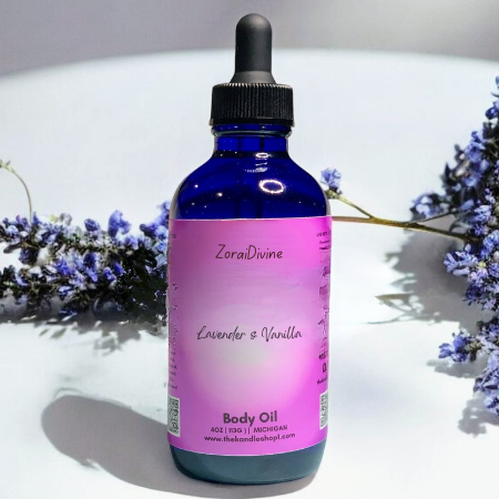 Bottle of ZoraiDivine Lavender & Vanilla body oil with lavender flowers on a white background