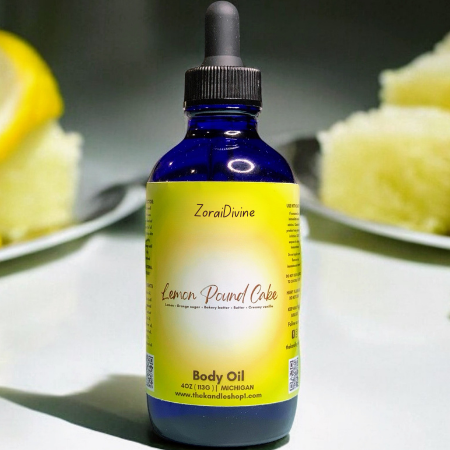 Bottle of ZoraiDivine Lemon Pound Cake body oil with slices of lemon pound cake in the background