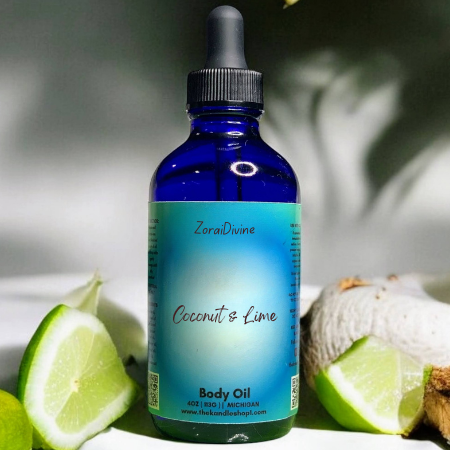 Bottle of ZoraiDivine Coconut & Lime body oil with limes and coconut in the background