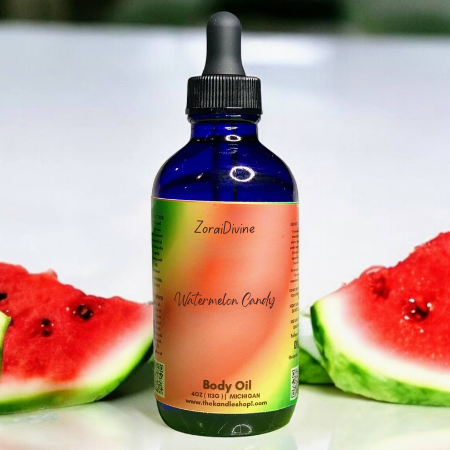 Bottle of ZoraiDivine Watermelon Candy Body Oil with watermelon slices on a white background