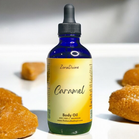Bottle of ZoraiDivine Caramel Body Oil with caramel candies in the background