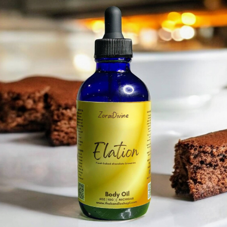 Bottle of ZoraiDivine Elation Body Oil with brownies in the background