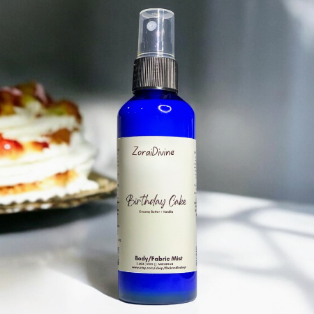 Body mist  birthday cake on a white surface with a blurred background