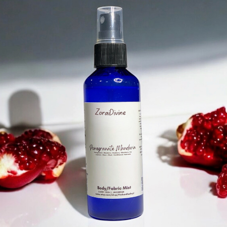 Body mist pomegranate mandarin with slices of pomegranate in the background.
