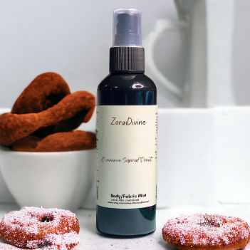 ZoraiDivine body mist bottle with donuts on a white surface