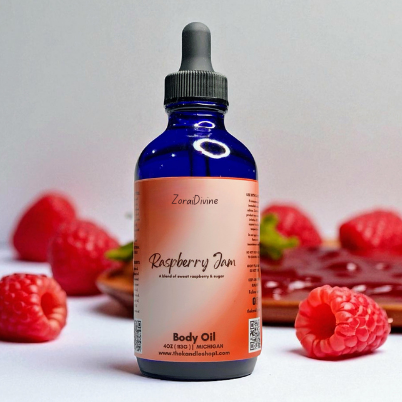 Bottle of Raspberry Jam body oil with raspberries in the background