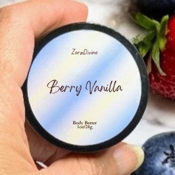 Hand holding a container of Zora Divine Berry Vanilla body butter with strawberries, blueberries  in the background.