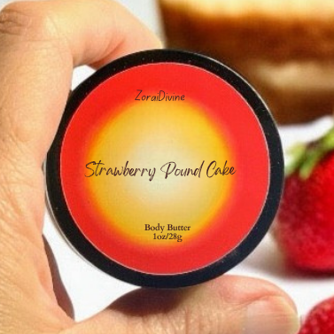 Hand holding a container labeled 'Strawberry Pound Cake' body butter with strawberries in the background