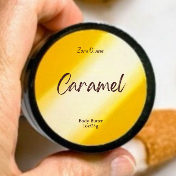 Hand holding a container of 'Caramel' body butter with caramel candy  in the background