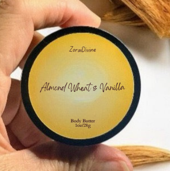 Hand holding a container of body butter Almond wheat & vanilla surrounded by wheat stalks.