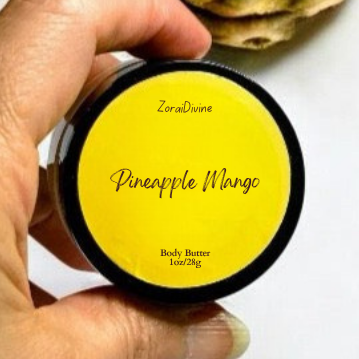Hand holding a container of 'Pineapple Mango' body butter with a white background