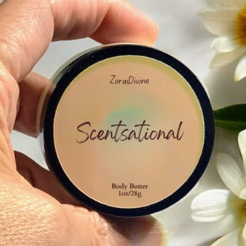 Hand holding a 'Scentsational' body butter container with flowers in the background