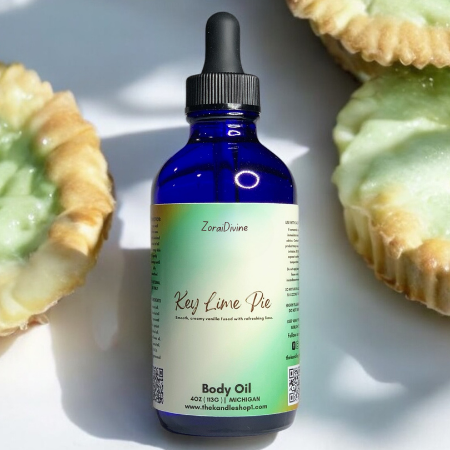 Body oil bottle labeled 'Key Lime Pie' with key lime pie tarts on a white background