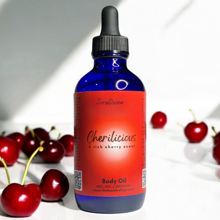 Bottle of Cherilicious body oil with cherries on a white background