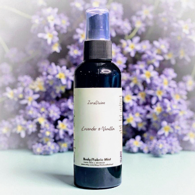 Body mist bottle lavender and vanilla against a soft floral background