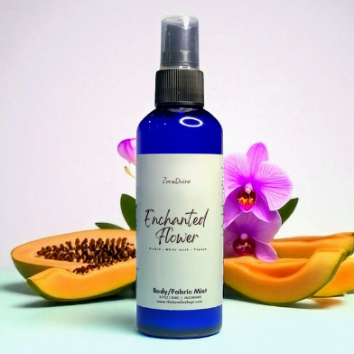 Body mist Enchanted flower with orchid flowers & papaya slices on the background.