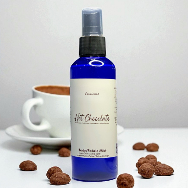 Body mist hot chocolate with a cup of hot chocolate on a white background