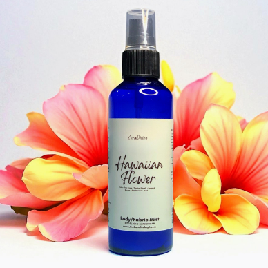 Body mist 'Hawaiian Flower' with pink and yellow flowers on a light gray background