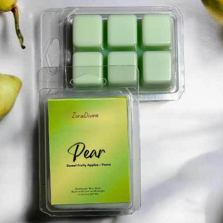 Wax melt Pear on a white countertop with pears on the background.