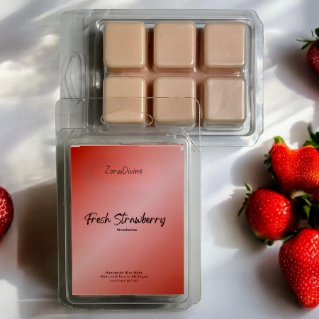 Wax melt packaging labeled 'Fresh Strawberry' with strawberries around on a white background